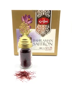 Bahraman Saffron with small glass jar with Saffron strands and some loose saffron strands in front.