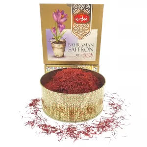 Bahraman Saffron with large metal jar filled with Top Negin Saffron and some Saffron sprinkled around.