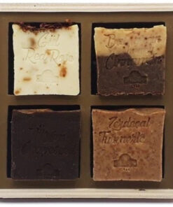 4 Bars Natural Olive Oil Soap - Box Set. A set of four soap bars in beige, light and dark brown mixed, black-brown, and dark orange.