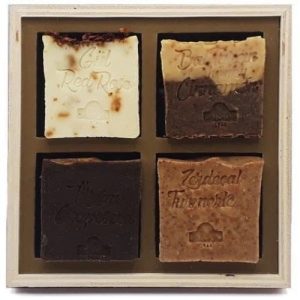 4 Bars Natural Olive Oil Soap - Box Set. A set of four soap bars in beige, light and dark brown mixed, black-brown, and dark orange.