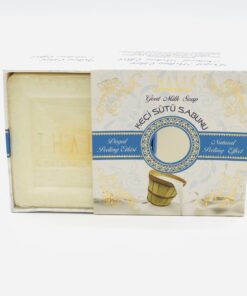 Half open beige, golden box with blue line showing a square white bar of Organic Goat Milk Soap.
