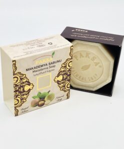 Open box with Macadamia nuts showing a hexagonal Organic Macadamia Soap.