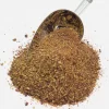 Pile of Salad Spice Mix with a silver coloured spice spoon stuck in the pile