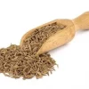 Wooden spice spoon overflowing with Cumin Seed.