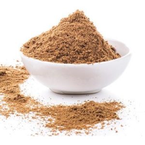 White bowl with a pile of Ground Coriander Seed and some sprinkled around