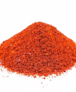 A pile of Ground Sweet Paprika on a white background